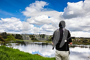 Male tourist taking photos at an artificial lake in the region of Boyaca in Colombia. La Playa reservoir located at the Tuta