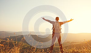 Male tourist on top of mountain in fog in autumn