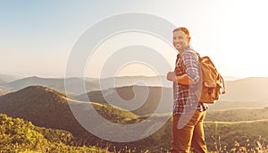 Male tourist on top of mountain in fog in autumn