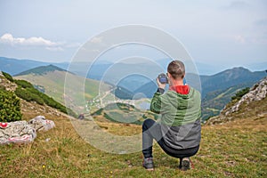 Male tourists are photographing a lake that is a natural attraction. Concept for Travel.