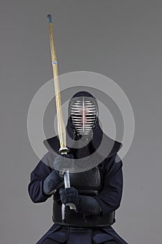 Male in tradition kendo armor with bamboo sword