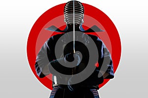 Male in tradition kendo armor with Samurai sword katana on red moon and white background.