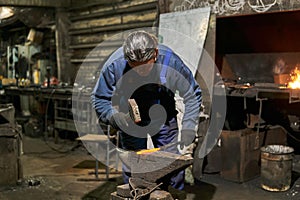 Male traditional blacksmith at work
