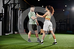 A male trainer demonstrates self-defense