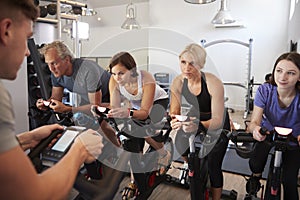 Male Trainer Taking Spin Class In Gym