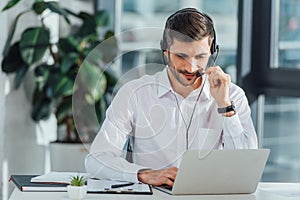 Male translator working online with headset