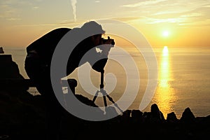 Male travel landscape photographer taking pictures of the view s