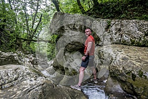 A male traveler admires the canyon of the Agura River in Sochi