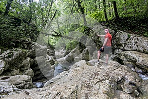 A male traveler admires the canyon of the Agura River in Sochi