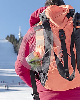 Male traveler with backpack at winter mountain ski resort. Back view. Winter vacation, tourism, sports, activity, hiking