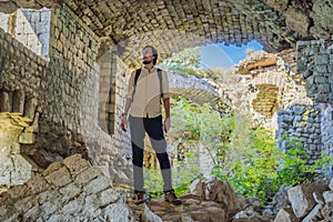 Male traveler in Collapsing tower of fortress Kosmac. Ancient Austro-Hungarian fortress built as a defensive structure