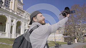 Male traveler with video camera