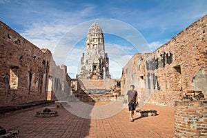 A male traveler walking around Wat Ratchaburana temple in Ayutthaya historical park, Phra Nakhon Si Ayutthaya province, Thailand