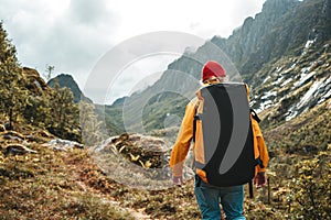 Male traveler wearing yellow jacket explore national park and hiking outdoor landscape