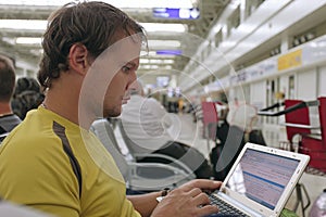 Male traveler working on his laptop computer