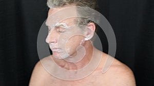 Male Turning to Each Side as a Bentonite Face Mask Dries