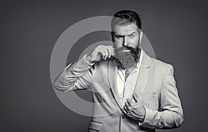 Male in tuxedo. Black and white. Man in suit. Male beard and mustache. Elegant man in business suit. Sexy male, brutal