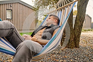 Male vacationer sleeping in the hammock outdoors