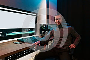 Male Video Editor Working on His Personal Computer with Big blank Display