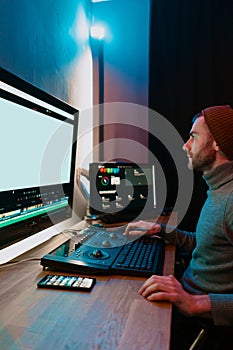Male Video Editor Working on His Personal Computer with Big blank Display photo