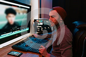 Male Video Editor Working on His Personal Computer with Big Display photo