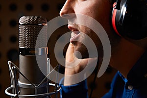 Male Vocalist Singing Into Microphone In Recording Studio
