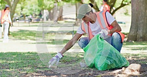 Male volunteer cleaning a park in his community. Responsible council workers, activists and volunteers collecting