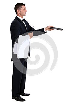 Male waiter holding out menu