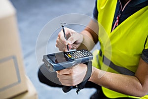 Male warehouse worker with barcode scanner.