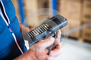 Male warehouse worker with barcode scanner.