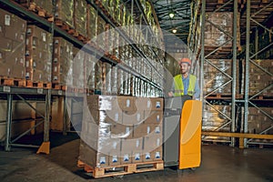 Male warehouse worker in helmet standing at the megastore