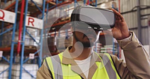 Male warehouse worker wearing VR headset in loading bay 4k