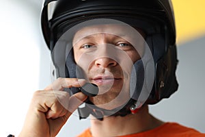 Male wearing helmet with microphone for hands free connection, interphone for motorcyclists photo