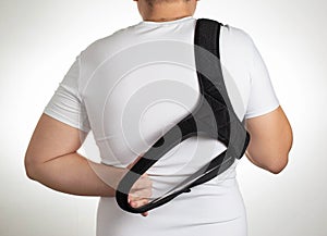 A male is wearing an orthopedic posture corrector. Treatment for stoop and back problems, close-up