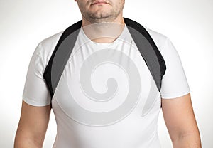 A male is wearing an orthopedic posture corrector. Treatment for stoop and back problems, close-up