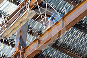 Male welding steel on a girder at heights, on a building structure in Mexico Guadalajara