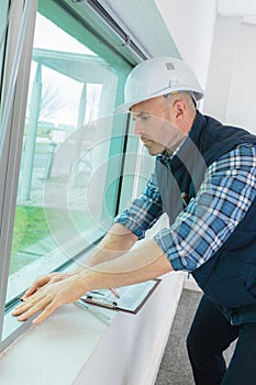 Male window fitter working indoors