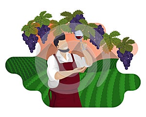 Male winemaker is tasting red wine background of vineyards and mountain landscape