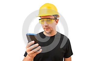 Male worker or builder in yellow helmet using smartphone isolated on white background. Construction concept