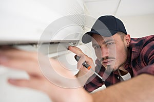 male worker checking state airconditioner