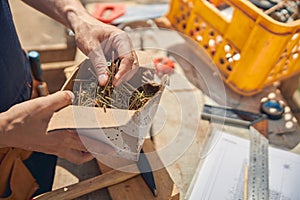 Male worker choosing the right metal bolts