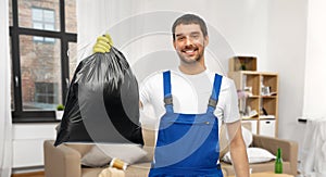 male worker or cleaner with garbage bag at home