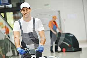 Male worker cleaning business hall