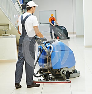 Male worker cleaning business hall