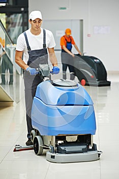 Male worker cleaning business hall