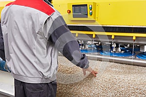 Male worker cleaning carpet on automatic washing machine equipment and dryer in the Laundry room. professional washing