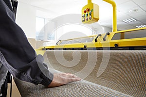 Male worker cleaning carpet on automatic washing machine equipment and dryer in the Laundry room. professional washing