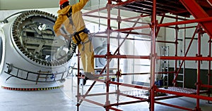 Male worker climbing scaffolding at solar station 4k