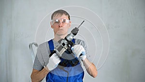 Male Worker with a Construction Drill in Hands