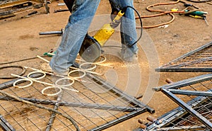 Male worker cutting steel fence in Nairobi, Kenya